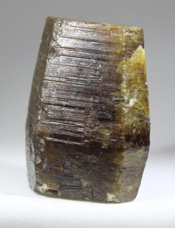 Large single Parisite-(Ce) crystal from Muzo showing a pronounced pseudohexagonal form and distinct transverse striations on the crystal faces