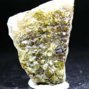 Reverse side of Vesuvianite specimen from Hamrefjell Norway with numerous dark green crystals