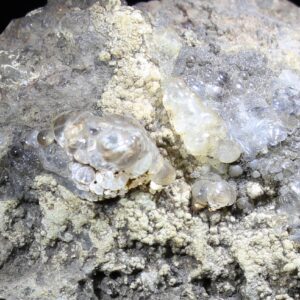 Glassy Hyalite Opal from Valeč Czech Republic on dark volcanic matrix